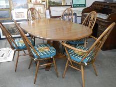 A good quality Ercol dining table with an extra leaf and six Ercol dining chairs, COLLECT ONLY.