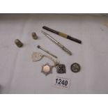 A mixed lot including silver fobs, silver badge, silver thimbles etc.,