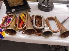 Three copper and one silver plate bugles.