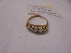 An 18ct gold ring set five diamonds, 3.3 grams, a/f.