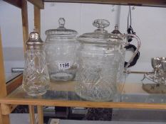 A cut glass engraved biscuit barrel, a biscuit barrel, cut glass jug & a silver topped sugar sifter.