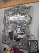 A large mirror in ornate silver coloured frame. COLLECT ONLY.