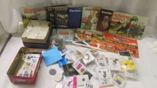 A box of tea cards in albums, loose cards and a large quantity of badges.