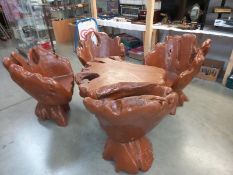 A 5 piece carved tree trunk garden set with 4 swivel chairs & a table