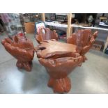 A 5 piece carved tree trunk garden set with 4 swivel chairs & a table