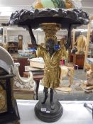 A glass top table supported by a Blackamoor figure. COLLECT ONLY.