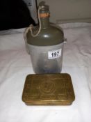 A 1914 Christmas ration tin and a flask