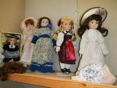 A quantity of porcelain headed dolls.