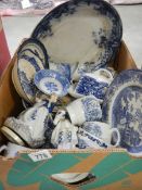 A box of assorted blue and white ceramics.