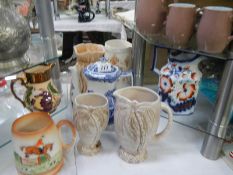 Ten assorted vintage jugs including Carlton, Devon ware etc.,