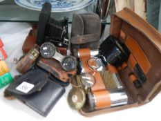 A mixed lot of leather cased shaving sets, binoculars, camera etc.,