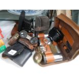 A mixed lot of leather cased shaving sets, binoculars, camera etc.,