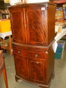 A mahogany two door cabinet with draw slide, COLLECT ONLY.