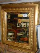 A gilt framed bevel edged mirror. COLLECT ONLY.