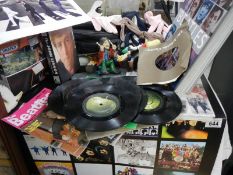 A good lot of Beatles memorabilia including 45 rpm records. 2 figures A/F