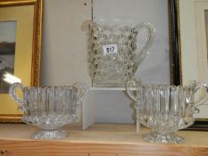 A good quality cube glass vase and a pair of double handled vases. Collect Only.