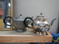 A silver plate and a pewter teapot.
