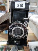 An Agfa folding camera in leather case.