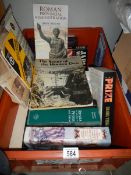 A box of war related books.