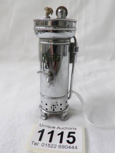 A very unusual chrome plated cigarette lighter in the form of a Stott's tea urn. Looks unused.