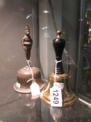 A brass bell and another bell with figure on handle.