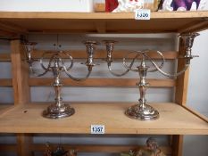 A pair of heavy silver plate candelabras.