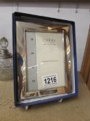 A boxed Hall marked silver 'Carrs' photo frame, 13 x 17 cm for 5" x 3.5" photo.