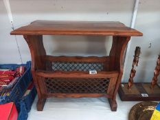 A teak side table/magazine rack with iron front panels. Collect Only.
