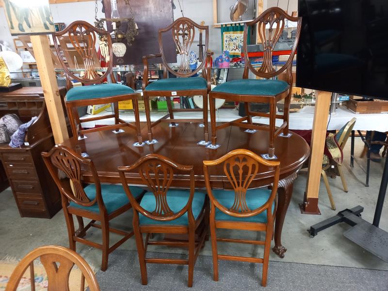 A mahogany oval extending dining table with one carver and five dining chairs, COLLECT ONLY.