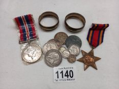 2 Silver napkin rings, 2 war medals and a small quantity of coins.