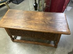 A heavy oak carved front coffer/chest with vine & grape decoration. COLLECT ONLY.