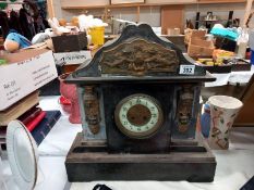 A large black slate mantle clock with brass ormolu embellishments, no key, no pendulum, no