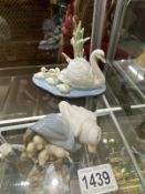 A Lladro swan with young and duck with young groups.