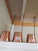 Three copper cider measures.