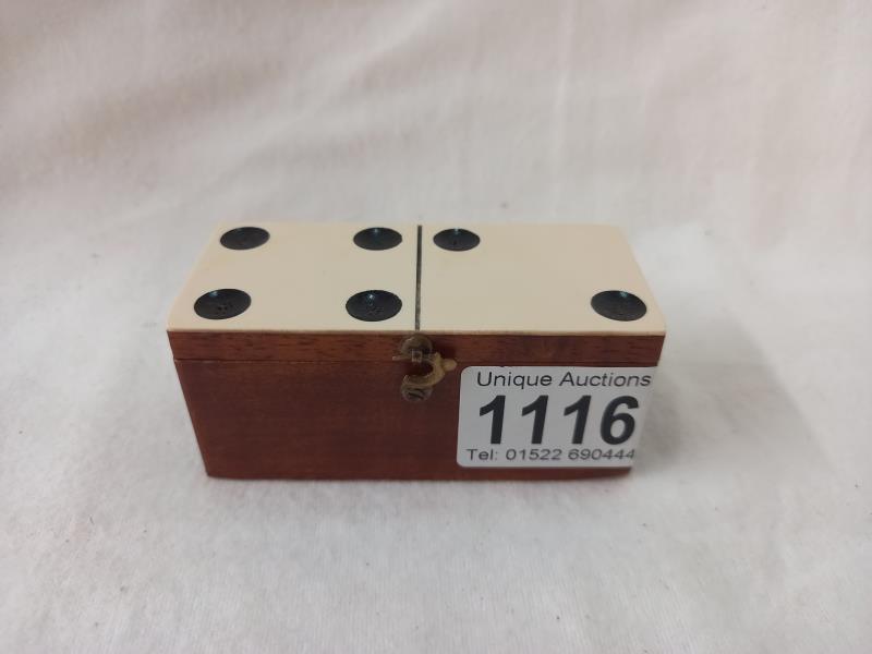 A set of mid 20th century miniature bone dominoes in original box.