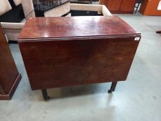 A 19th century mahogany Pembroke table on casters.