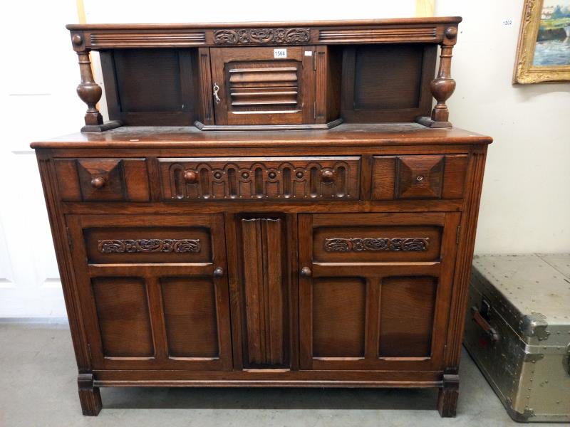 A mid-20th century oak sideboard in good condition, (knob is off right hand drawer but is present)
