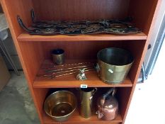 Brassware including toasting forks, shells case, horse brasses etc, 3 shelves.