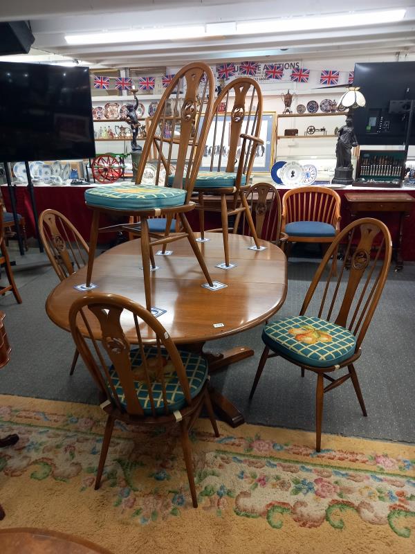 A good quality Ercol dining table with an extra leaf and six Ercol dining chairs, COLLECT ONLY.