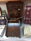 An Edwardian oak framed fire screen with hammered copper plated ship image & a wooden coal box