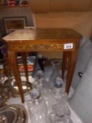 An Italian inlaid musical side table, missing keys to wind up & lock, the legs wobble (height 46cm x