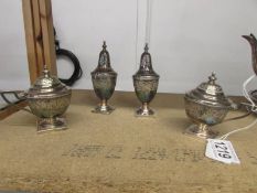 A four piece silver plate condiment set.