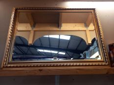 A gilt framed bevel edged mirror. COLLECT ONLY. 108cm x 77cm