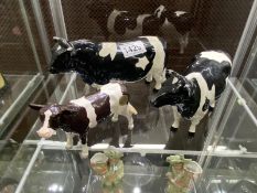 A Beswick friesian bull CH Coddington hilt bar and CH Claybury leegwater and a calf.