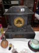 A large black slate mantle clock with brass ormolu embellishments, no key, no pendulum, springs ok
