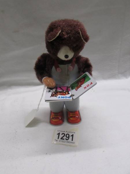 A clockwork reading bear, made in Japan, in working order.