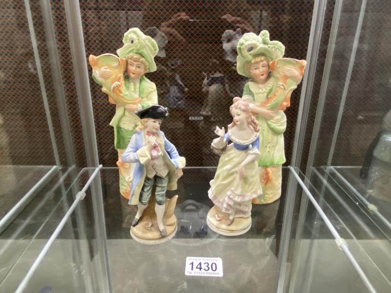 Two pairs of Bisque porcelain figures.