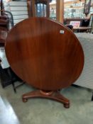 A Victorian mahogany tip up dining table. COLLECT ONLY.