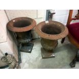 A pair of cast iron garden urns. Height 53cn x Diameter 39cm. Base 31cm x 31cm.