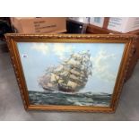 A large gilt framed print of 2 Galleon sailing ships.